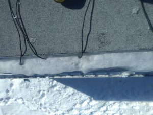 Aice build up on a roof highlighting the possible need for attic insulation in barrie